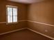 Bedroom with carpet and trim, light coming from window, tan walls at 1818 Brandy Woods Se Dr, Conyers, GA 30013