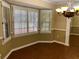Dining room featuring tile floors, bay window, neutral walls, chandelier, and large wall mirror at 1818 Brandy Woods Se Dr, Conyers, GA 30013