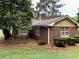 Brick home with manicured lawn and trimmed bushes at 1818 Brandy Woods Se Dr, Conyers, GA 30013
