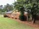 A beautiful brick house with manicured lawn and mature tree at 1818 Brandy Woods Se Dr, Conyers, GA 30013
