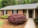 Charming brick home featuring a covered front porch and meticulously landscaped front yard at 1818 Brandy Woods Se Dr, Conyers, GA 30013