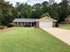 A well maintained brick home with a two car garage and mature landscaping at 1818 Brandy Woods Se Dr, Conyers, GA 30013