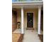 Covered front porch with decorative door and nice accents including a small flower stand at 1818 Brandy Woods Se Dr, Conyers, GA 30013