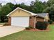 A large two car garage with brick siding and a spacious driveway at 1818 Brandy Woods Se Dr, Conyers, GA 30013