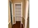 Hallway linen closet with white wire shelving and wood flooring at 1818 Brandy Woods Se Dr, Conyers, GA 30013