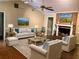 Staged living room featuring a brick fireplace, hardwood floors, and a ceiling fan at 1818 Brandy Woods Se Dr, Conyers, GA 30013
