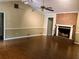 Spacious living room with hardwood floors, brick fireplace, and neutral wall paint at 1818 Brandy Woods Se Dr, Conyers, GA 30013
