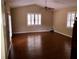 Living room featuring hardwood floors, brick fireplace, and neutral wall paint at 1818 Brandy Woods Se Dr, Conyers, GA 30013
