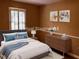 Staged bedroom with a large bed, dresser, wood floor, and window with lots of light at 1818 Brandy Woods Se Dr, Conyers, GA 30013