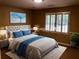 Staged bedroom features a large bed, window, and decorative wall art at 1818 Brandy Woods Se Dr, Conyers, GA 30013