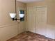 Mud room or utility area with tile flooring, doors, and a modern light fixture at 1818 Brandy Woods Se Dr, Conyers, GA 30013