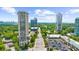 Aerial view showcasing a high-rise condo with a skyline view surrounded by trees at 2881 Peachtree Ne Rd # 1102, Atlanta, GA 30305