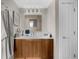 Cozy bathroom with a light wood vanity, white countertop, silver framed mirror and silver fixtures at 2881 Peachtree Ne Rd # 1102, Atlanta, GA 30305