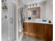 Bathroom featuring a wooden vanity cabinet, quartz countertop, and a walk-in shower at 2881 Peachtree Ne Rd # 1102, Atlanta, GA 30305