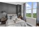 Cozy bedroom with luxurious bedding, natural light and a view to the neighborhood at 2881 Peachtree Ne Rd # 1102, Atlanta, GA 30305