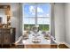 Dining room features place settings and large windows with views of the surrounding trees and sky at 2881 Peachtree Ne Rd # 1102, Atlanta, GA 30305