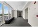 Modern hallway with large windows offering city views, a sleek bench, and access to elevators at 2881 Peachtree Ne Rd # 1102, Atlanta, GA 30305