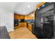 Stylish kitchen featuring wood cabinetry, black appliances, and stone countertops at 2881 Peachtree Ne Rd # 1102, Atlanta, GA 30305