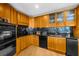 Updated kitchen with wood cabinets, stainless appliances, and granite countertops at 2881 Peachtree Ne Rd # 1102, Atlanta, GA 30305