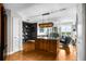 Open-concept kitchen with modern island, hardwood floors, decorative chandelier and built-in shelves at 2881 Peachtree Ne Rd # 1102, Atlanta, GA 30305