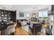Well-lit living space with comfortable seating, dining area with city views, fireplace, and custom shelving at 2881 Peachtree Ne Rd # 1102, Atlanta, GA 30305
