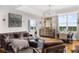 Bright living room featuring hardwood floors, a modern chandelier, comfortable seating, and a dining area with city views at 2881 Peachtree Ne Rd # 1102, Atlanta, GA 30305