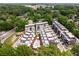 An aerial view displays modern townhomes with pools, rooftop terraces, and lush green surroundings at 307 Cedar Dust Dr, Decatur, GA 30030