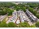 Aerial view showcases a new community featuring townhomes, mature trees and an outdoor pool at 307 Cedar Dust Dr, Decatur, GA 30030