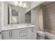 Well-lit bathroom with double sinks, quartz countertops, modern fixtures, and a shower-tub combo at 307 Cedar Dust Dr, Decatur, GA 30030