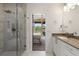 Beautiful primary bathroom with glass-enclosed shower and a glimpse of a bedroom through the doorway at 307 Cedar Dust Dr, Decatur, GA 30030