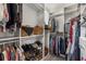 Walk-in closet with custom shelving, shoe racks, and rods for hanging clothes provides organized storage at 307 Cedar Dust Dr, Decatur, GA 30030