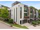 Contemporary townhome boasts white painted brick, black trim, private balconies, and a two-car garage at 307 Cedar Dust Dr, Decatur, GA 30030