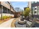 A community fire pit with gray Adirondack chairs offers a relaxing outdoor space at 307 Cedar Dust Dr, Decatur, GA 30030