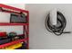 The garage features a Tesla charger and red shelving units for storage at 307 Cedar Dust Dr, Decatur, GA 30030
