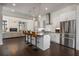 Modern eat-in kitchen with stainless steel appliances, bar stool seating, and an open view to the living room at 307 Cedar Dust Dr, Decatur, GA 30030