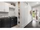 Convenient laundry room featuring a washer and dryer, storage cabinets, and a sliding barn door at 307 Cedar Dust Dr, Decatur, GA 30030