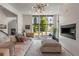 Bright living room features a fireplace, a large window, and a comfortable couch with pillows at 307 Cedar Dust Dr, Decatur, GA 30030
