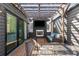 Cozy outdoor living space with a fireplace, TV, and comfortable seating under a charming pergola at 307 Cedar Dust Dr, Decatur, GA 30030