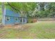 Backyard featuring a grassy lawn, chain link fence, trees and deck area at 3178 Booths Ct, Dacula, GA 30019