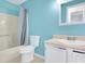 Bathroom featuring turquoise walls, a vanity, a toilet and a shower with curtain at 3178 Booths Ct, Dacula, GA 30019