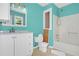 Turquoise bathroom featuring a toilet, vanity with mirror, and shower with an open wall at 3178 Booths Ct, Dacula, GA 30019