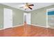 Bedroom with hardwood floors, ceiling fan, and views of an adjacent bathroom and bedroom at 3178 Booths Ct, Dacula, GA 30019