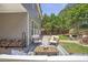Backyard patio with chairs, a table, and a view of the home and lush landscaping at 4765 Silver Leaf Dr, Cumming, GA 30040