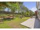 Large backyard with a stone patio, a firepit, and lush landscaping at 4765 Silver Leaf Dr, Cumming, GA 30040