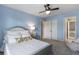 A bright bedroom with a fan, large closet and soft blue walls at 4765 Silver Leaf Dr, Cumming, GA 30040