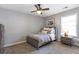 Cozy bedroom featuring neutral tones, a ceiling fan, and a bedside table with a lamp at 4765 Silver Leaf Dr, Cumming, GA 30040