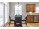 Charming breakfast nook features a round glass table, seating for four, and natural light at 4765 Silver Leaf Dr, Cumming, GA 30040