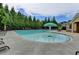 Large community pool with zero entry, mushroom umbrella, and plenty of seating at 4765 Silver Leaf Dr, Cumming, GA 30040