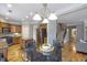 Bright, open-concept kitchen with stainless steel appliances, granite countertops, and hardwood floors at 4765 Silver Leaf Dr, Cumming, GA 30040