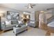 Spacious living room with hardwood floors, stylish decor, staircase, and easy access to other areas at 4765 Silver Leaf Dr, Cumming, GA 30040